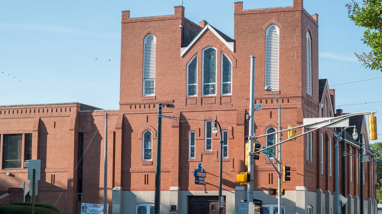 The red brick front of Historic Ebenezer Baptist Church on Auburn Avenue in Atlanta under a blue sky
