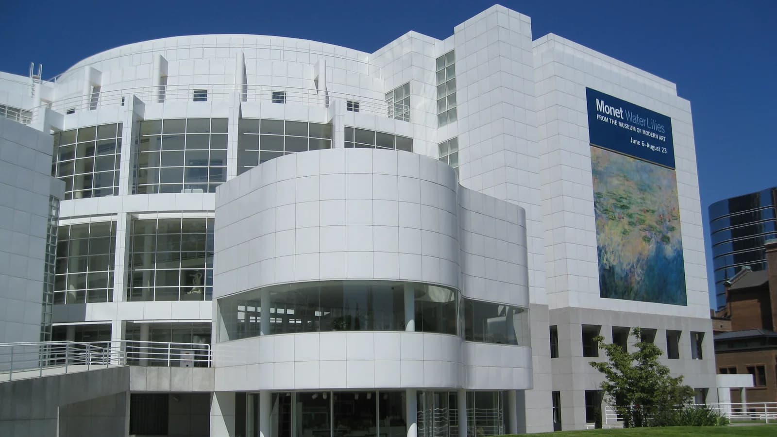 The bright white enameled panels and curved glass atrium of the High Museum of Art on Peachtree Street