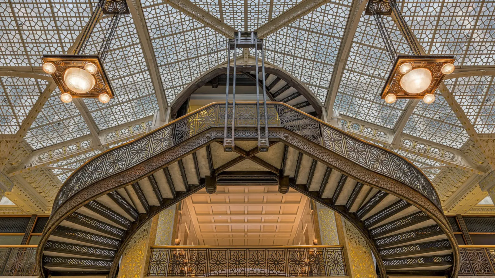 Ornate iron staircase under the glass skylight in the Rookery Building's light court lobby
