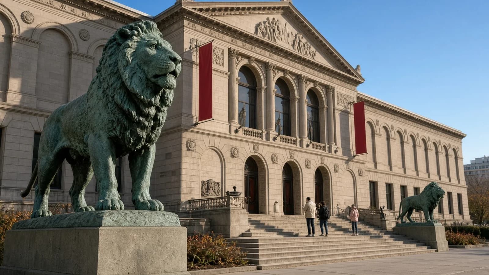Art Institute of Chicago's Michigan Avenue entrance with bronze lion statues and visitors on the steps, clear day