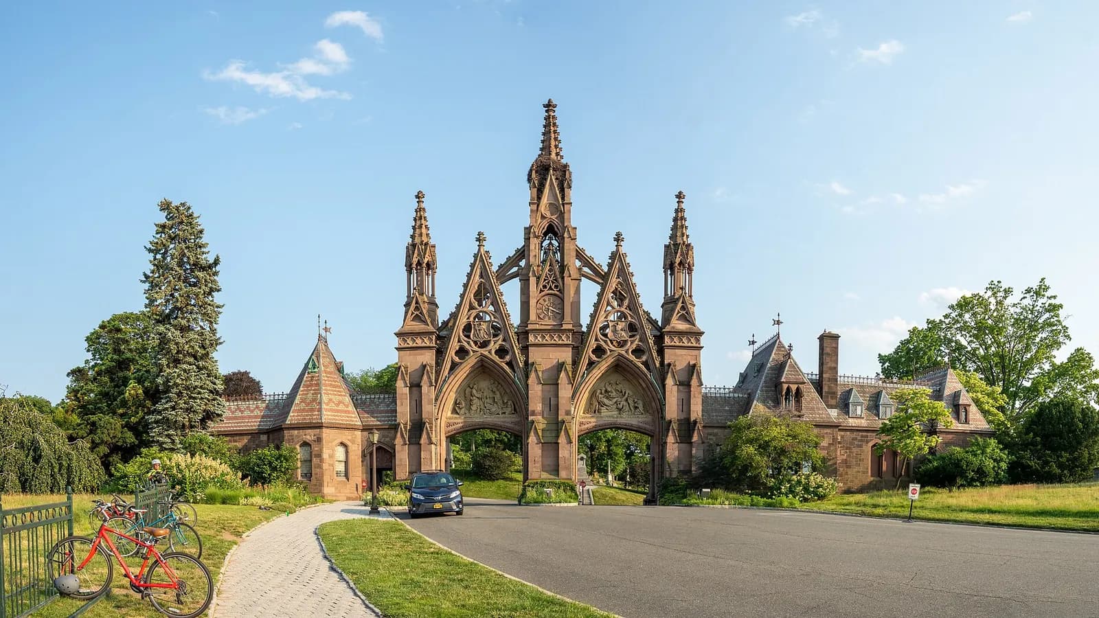 Gothic Revival brownstone main gate of Green-Wood Cemetery in Brooklyn under a clear blue sky