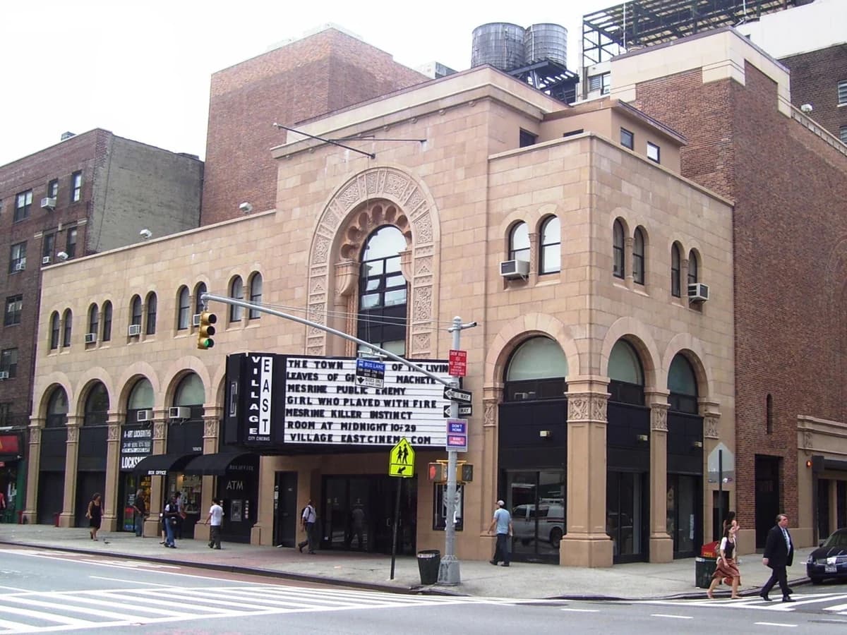 Village East cinema on Second Avenue, a tan brick building with tall arched windows, an ornate arched entrance and a marquee